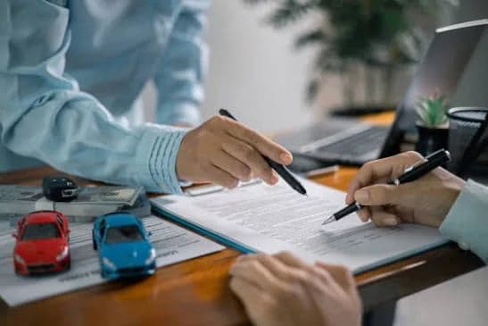 An advisor reviewing an auto insurance policy with a customer